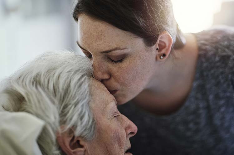 lady kissing grandmothers head