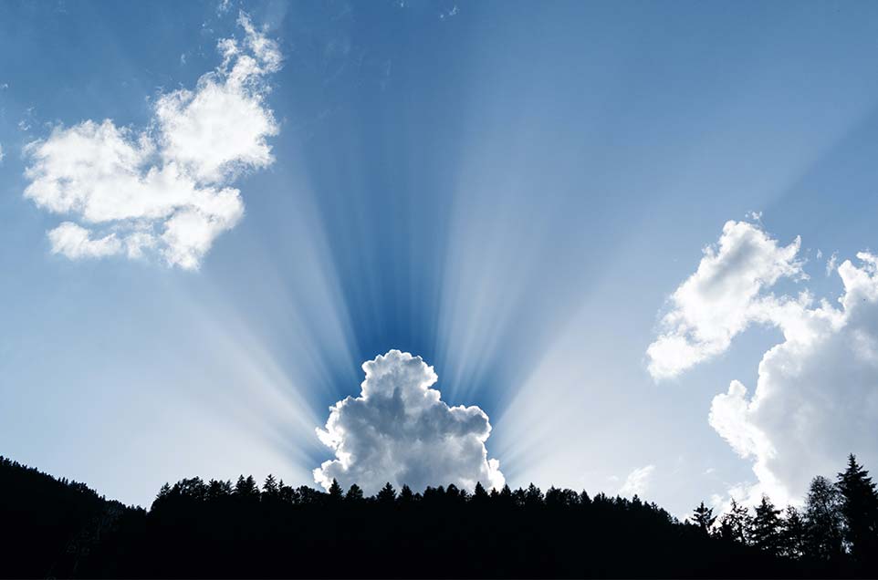 sun rays shining behind cloud